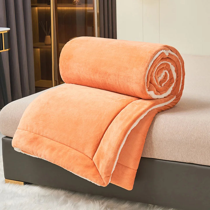 Rolled orange milk fleece blanket with lambswool lining, soft Nordic throw for bed or sofa styling