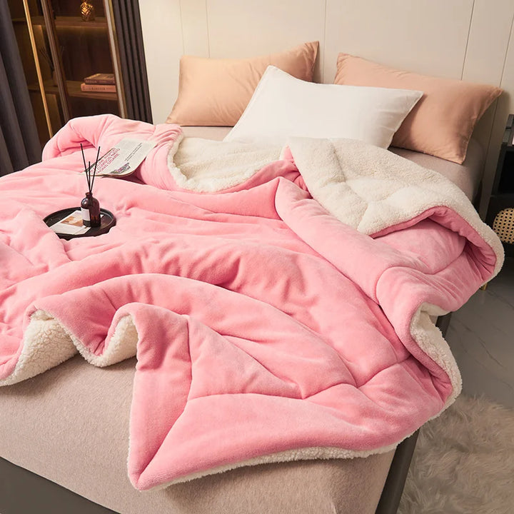 Pink milk fleece blanket with lambswool lining on bed, cosy Scandinavian throw for bedroom styling