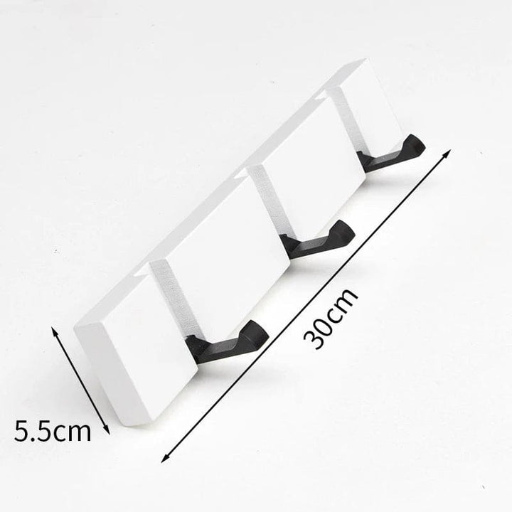 White three-hook wall rack measuring 30 cm (11.8 in) by 5.5 cm (2.2 in) for compact storage.