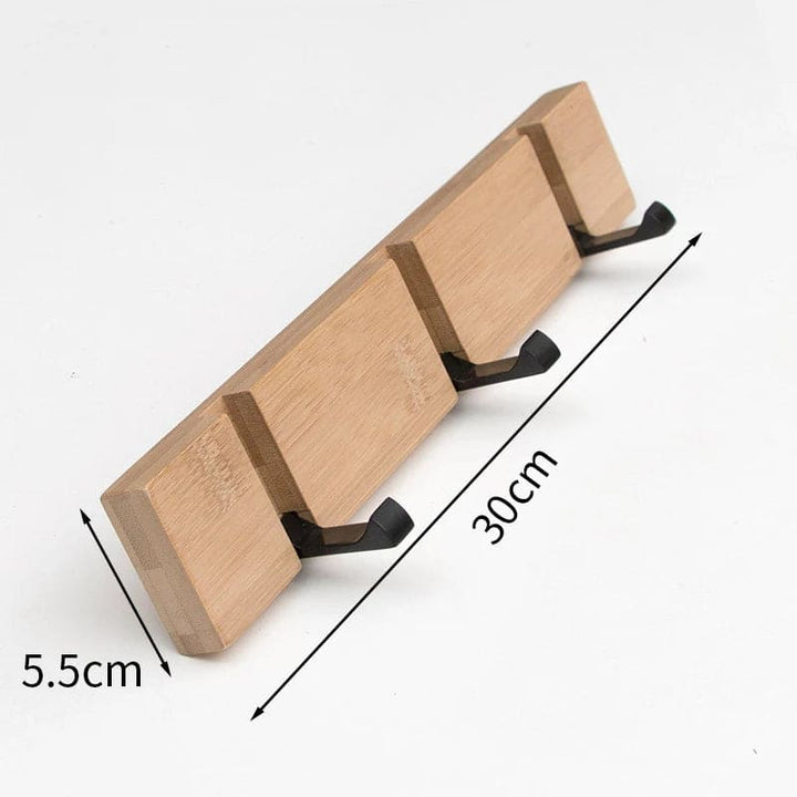 Bamboo three-hook wall rack measuring 30 cm (11.8 in) by 5.5 cm (2.2 in) for small spaces.