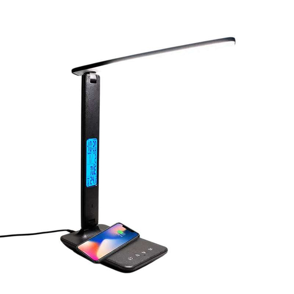 Black LED desk lamp with wireless charging pad and blue LCD display on a modern workspace