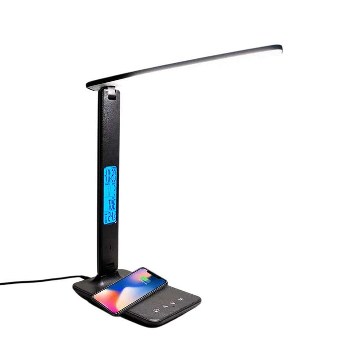 Black LED desk lamp with wireless charging pad and blue LCD display on a modern workspace