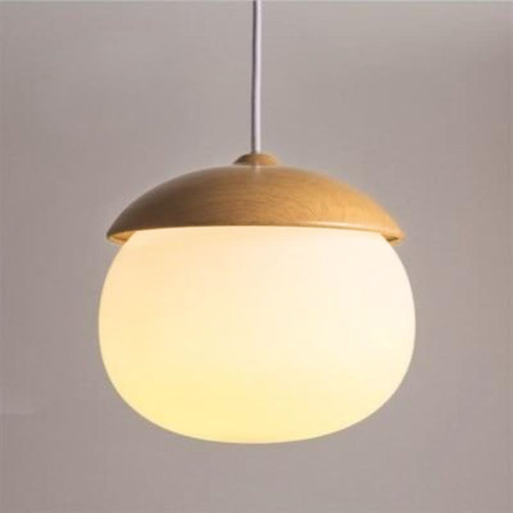Large round pendant lamp with natural wood top and frosted glass shade, ideal for kitchen island lighting.