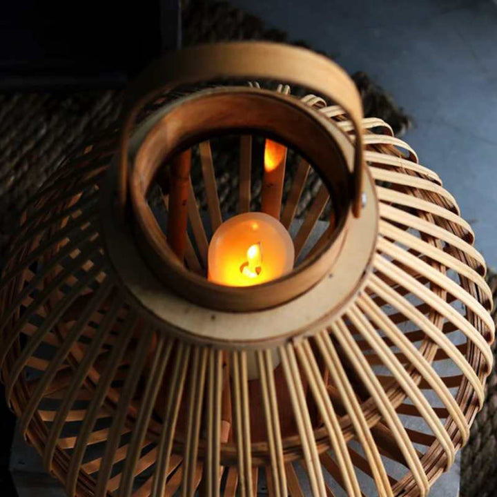 Top view of bamboo candle holder showing warm candlelight through wooden slats