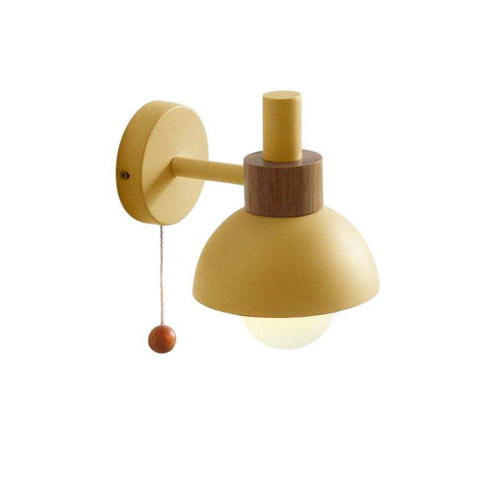 Pastel yellow wall sconce with wooden detail and matte globe shade, ideal for Nordic home décor lighting.