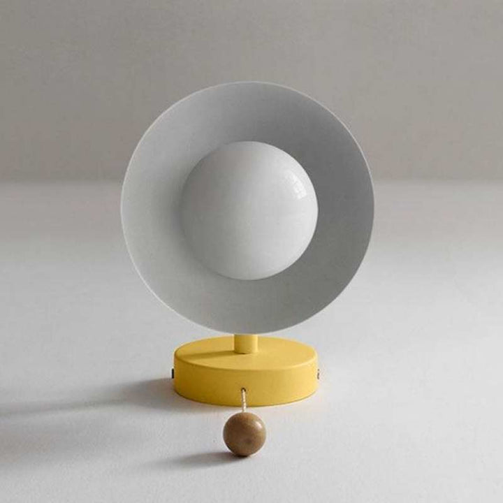 Minimalist yellow wall sconce with white inner shade and wooden pull switch, Scandinavian-inspired lighting.