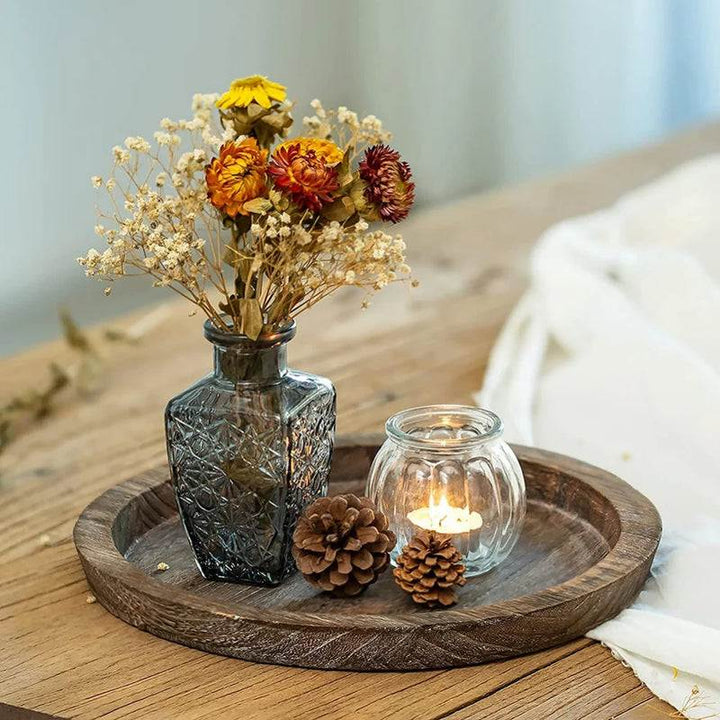 Wooden tray on wooden table with dried flowers and candle, cozy Scandinavian home styling