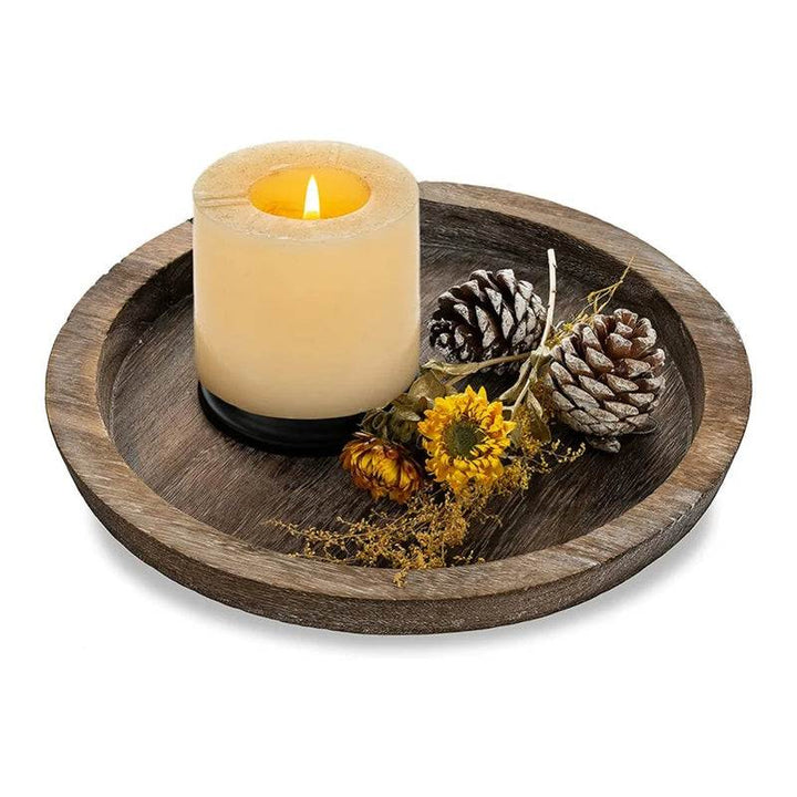 Rustic wooden tray with large candle, pinecones, and dried flowers for minimalist centerpiece décor