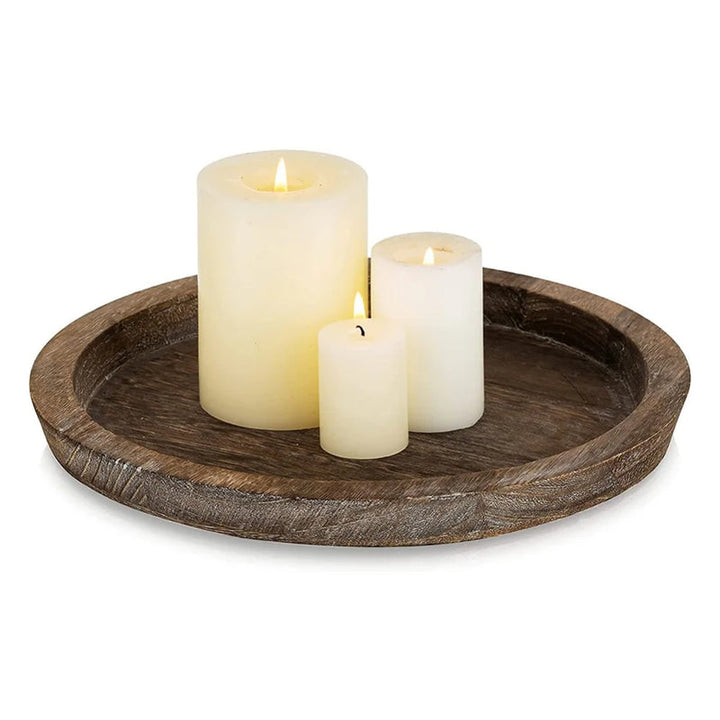 Three white pillar candles on brown wooden tray, rustic farmhouse-style display