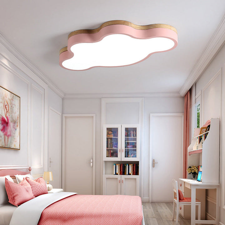 Pink cloud ceiling light in a girl’s bedroom with matching pink bedding and Scandinavian décor.