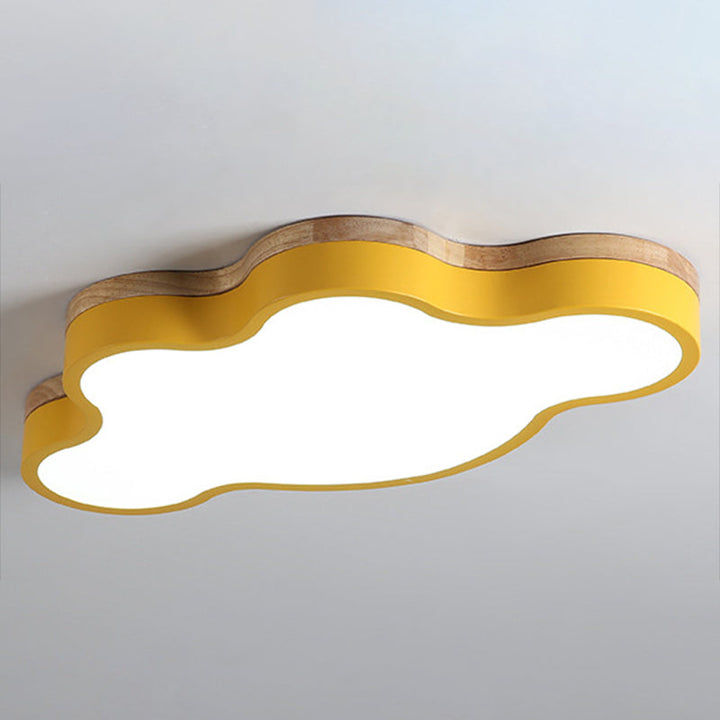 Yellow metal cloud ceiling light with wooden trim mounted on a white ceiling for a cheerful Nordic style.