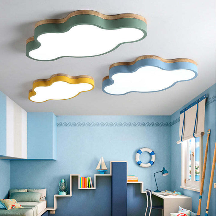 Set of three cloud-shaped LED ceiling lights in blue, yellow, and green decorating a children’s playroom.