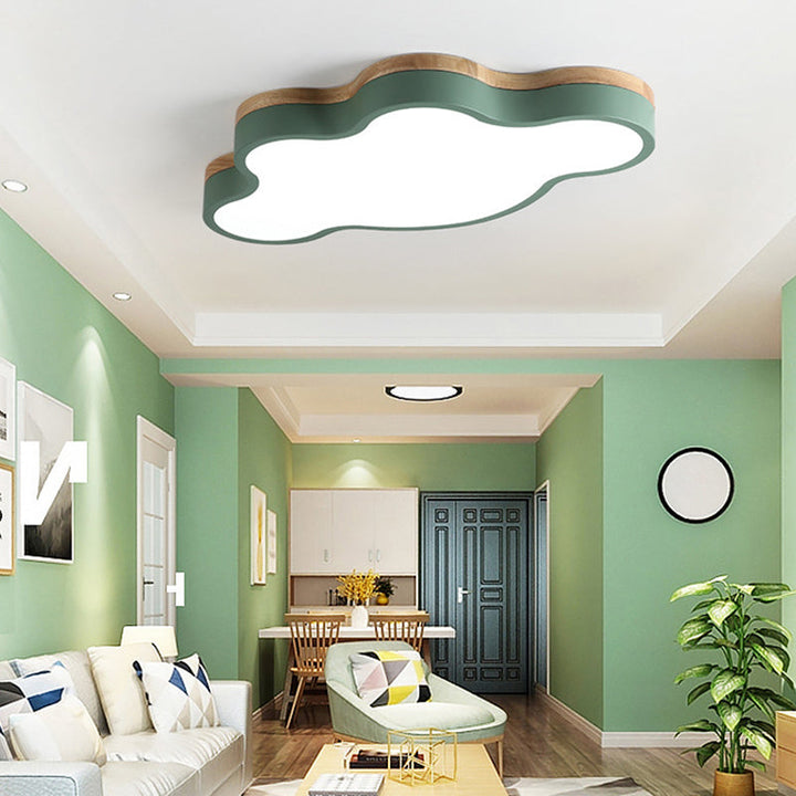 Green cloud LED ceiling lamp illuminating a modern Scandinavian living room with soft lighting.