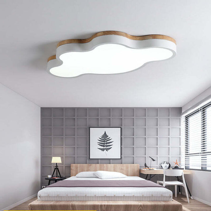 White cloud ceiling light above a minimalist grey and wood bedroom, offering soft modern illumination.