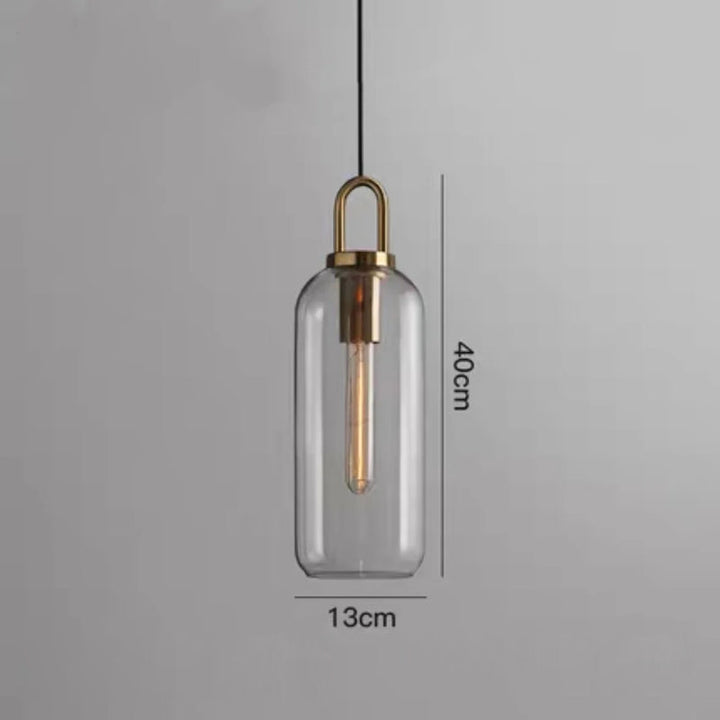 Clear capsule glass pendant light with slim metal top measuring 40 cm by 13 cm with E27 light fitting