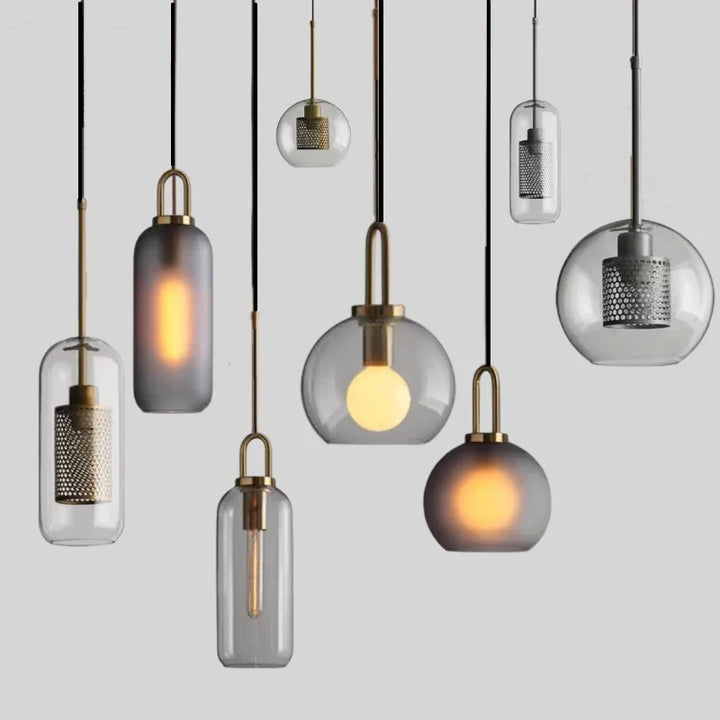 Assorted Nordic glass pendant lights with metal fittings in various round and capsule shapes