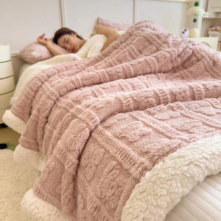 Blush pink faux lambswool fleece blanket on bed, cosy Scandinavian throw for bedroom styling