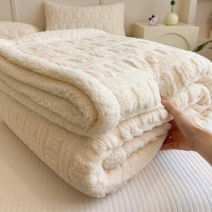 Hand touching fluffy cream blanket, soft jacquard faux lambswool texture for modern home comfort