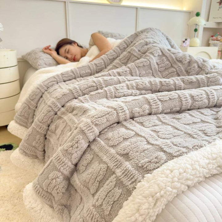 Soft grey faux lambswool blanket on bed, thick fleece throw for modern Scandinavian bedroom décor