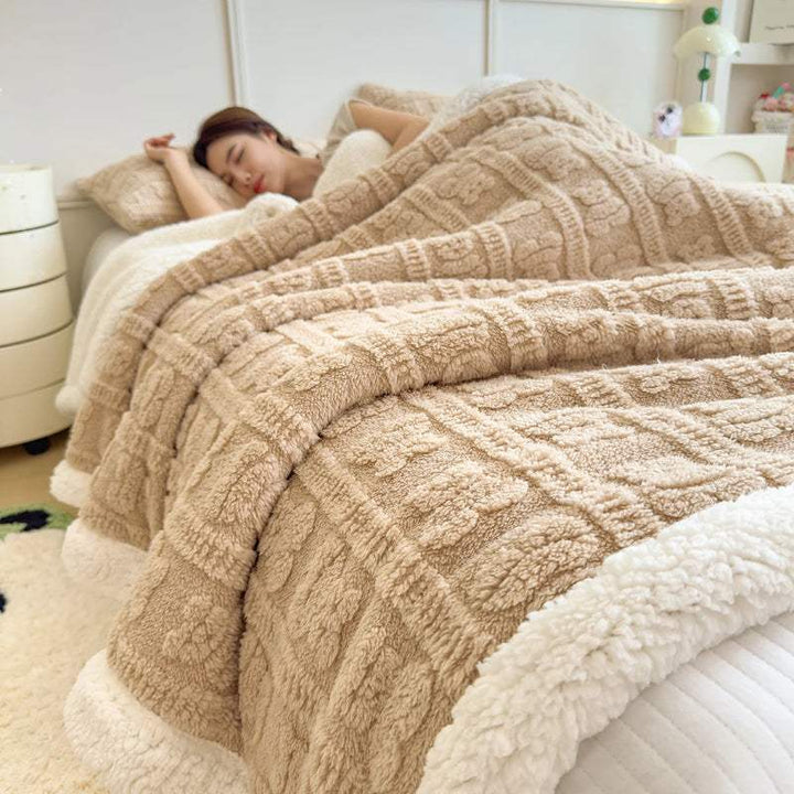 Khaki faux lambswool blanket on bed, textured coral fleece design for warm minimalist home look