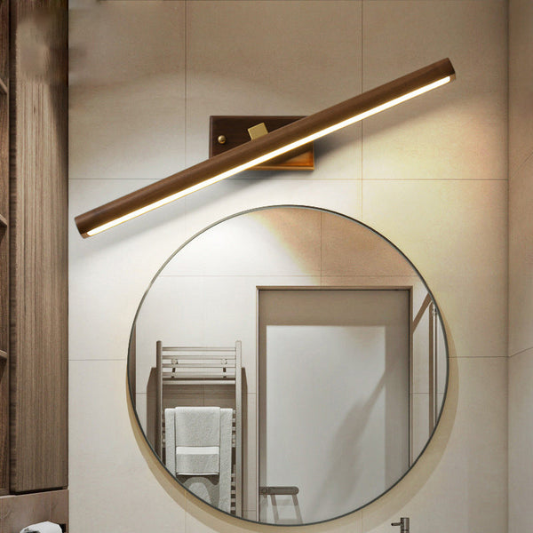 Dark wood LED wall sconce above round mirror, warm light for Scandinavian bathroom décor
