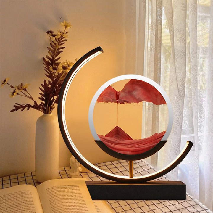 Warm-lit crescent LED lamp showcasing red sand scenery in a rotating round frame.