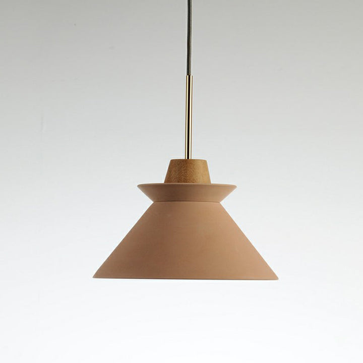 Pink Nordic pendant light with wood accent and brass detail, minimalist Scandinavian ceiling design.
