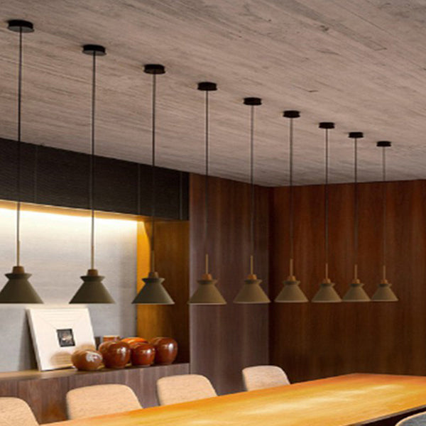Set of hanging Nordic cement pendant lights in warm dining room setting, modern minimalist décor.