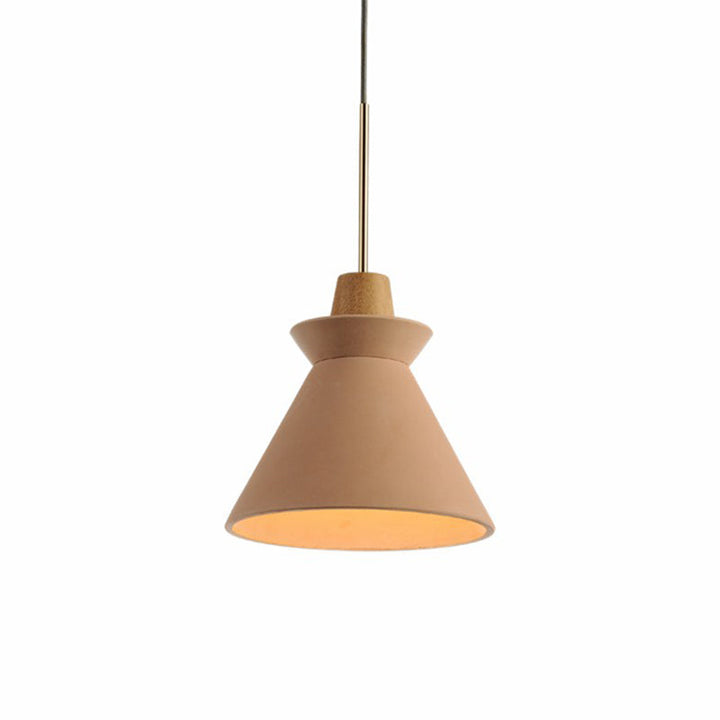 Pink cement pendant light with wood accent in modern Scandinavian dining room setting.