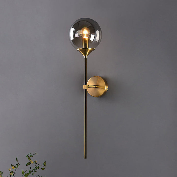 Smoke grey globe glass wall light on dark grey wall, featuring minimalist Scandinavian design.