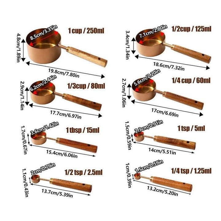 Gold measuring cups and spoons with wood handles displayed with detailed size dimensions